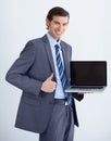 Invaluable business tool. A young businessman endorsing a laptop with a thumbs up. Royalty Free Stock Photo