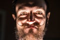 Inventor Hipster with Beard and Mustages in the Dark Room. Smiling Trickster. Royalty Free Stock Photo