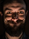 Inventor Hipster with Beard and Mustages in the Dark Room. Smiling Trickster.