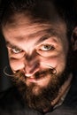 Inventor Hipster with Beard and Mustages in the Dark Room. Smiling Trickster.