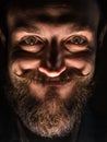 Inventor Hipster with Beard and Mustages in the Dark Room. Smiling Trickster. Royalty Free Stock Photo