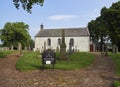 Inverarity kirk or Church with a board near the path giving details of its Minister and opening times.