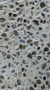 Negative image - Pebbly pattern background, pebbles embedded in concrete.