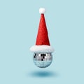 Inverted disco ball ice cream and santa hat waffle cone levitates on blue background. Minimal Christmas party concept Royalty Free Stock Photo