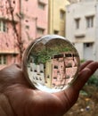 An inverted image of buildings through a lens ball