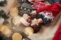 Inverted photo of young couple that celebrating new year and holds gift box in hands