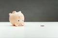 Inverted piggy bank, spilled gold coins. Opening piggy bank. last coin from the piggy bank. The concept of