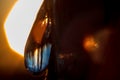 Inverted sunset view and blue sky in a drop of pine resin Royalty Free Stock Photo