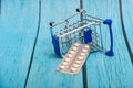 Inverted trolley and pills and medicines lie nearby, the concept of the uselessness and futility of treatment