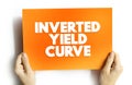 Inverted Yield Curve - shows that long-term interest rates are less than short-term interest rates, text concept on card