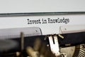 Invest in knowledge symbol. Text `invest in knowledge` typed on retro typewriter. Business and invest in knowledge growth concep