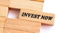 INVEST NOW word written on wood block. Invest Now text on table, concept Royalty Free Stock Photo