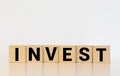 invest word written on wood block Royalty Free Stock Photo