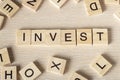 Invest word written on wood block Royalty Free Stock Photo