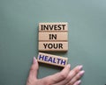 Invest in your Health symbol. Concept words Invest in your Health on wooden blocks. Businessman hand. Beautiful grey green Royalty Free Stock Photo