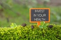 Invest in your health text on small blackboard Royalty Free Stock Photo