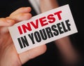 Invest in Yourself message on business card shown by a businessman. Education importance concept Royalty Free Stock Photo