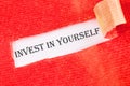 invest in yourself word on a white background under torn paper Royalty Free Stock Photo