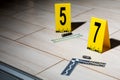 The investigation of the crime scene-collecting bullet shells on the tiled floor