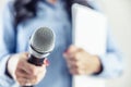 Investigative journalist with microphone in other hand notebook - Close up Royalty Free Stock Photo