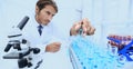 Chemist looking at test-tubes with blue liquids Royalty Free Stock Photo