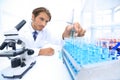 Chemist looking at test-tubes with blue liquids Royalty Free Stock Photo