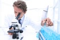 Chemist looking at test-tubes with blue liquids Royalty Free Stock Photo