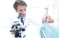 Chemist looking at test-tubes with blue liquids Royalty Free Stock Photo