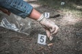 Investigator collects evidence - crime scene investigation