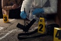 Investigator and criminologist working at crime scene outdoors, closeup Royalty Free Stock Photo