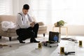 Investigator working at crime scene in living room Royalty Free Stock Photo