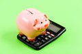 Investing gain profit. Economics and business administration. Piggy bank money savings. Piggy bank pig and calculator Royalty Free Stock Photo