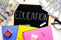 Investing time and money into education concept. Different school supplies, banknotes. Top view, close up. Royalty Free Stock Photo