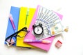 Investing time and money into education concept. Different school supplies, banknotes. Top view, close up. Royalty Free Stock Photo