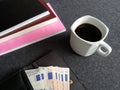 wallet of woman with euro banknotes, coffee cup and stacked books Royalty Free Stock Photo