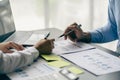 Investment finance concept, group of young businessmen pointing to graph Business