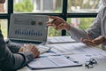 Investment finance concept, group of young businessmen pointing to graph Business