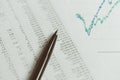 Investment, financial report statistic concept, close-up of black pen on printed stock exchange data price number or valuation ta Royalty Free Stock Photo