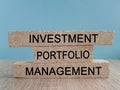 Investment portfolio management symbol. Concept words Investment portfolio management on brick blocks. Beautiful blue background.