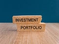 Investment portfolio symbol. Brick blocks with concept words Investment portfolio on blue background.