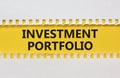 Investment portfolio symbol. Yellow and white paper with concept words Investment portfolio on beautiful white background.