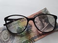 investment and promotion for a better vision, Honduran banknote of five lempiras and black plastic frame glasses Royalty Free Stock Photo