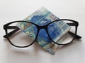 investment and promotion for a better vision, Hong Kong banknote of twenty dollars and black plastic frame glasses Royalty Free Stock Photo