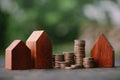 Investment in the real estate business. Money coin stack growing graph and wood house model. Loans for the purchase of residential Royalty Free Stock Photo