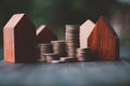 Investment in the real estate business. Money coin stack growing graph and wood house model. Loans for the purchase of residential Royalty Free Stock Photo