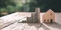 Investment in the real estate business. Money coin stack growing graph and wood house model. Loans for the purchase of residential Royalty Free Stock Photo