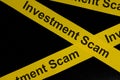 Investment scam and fraud alert, caution and warning concept. Yellow barricade tape with word