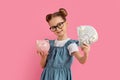 Investments Concept. Smiling Little Girl Holding Piggybank And Dollar Cash In Hands Royalty Free Stock Photo