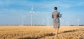 Investor in green energy looking at her wind turbines