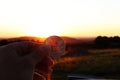 A Investor holding silver bitcoin in the background there is awesome sunset